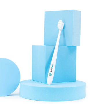 white tooth brush with a SmileFresh brand name on the handle